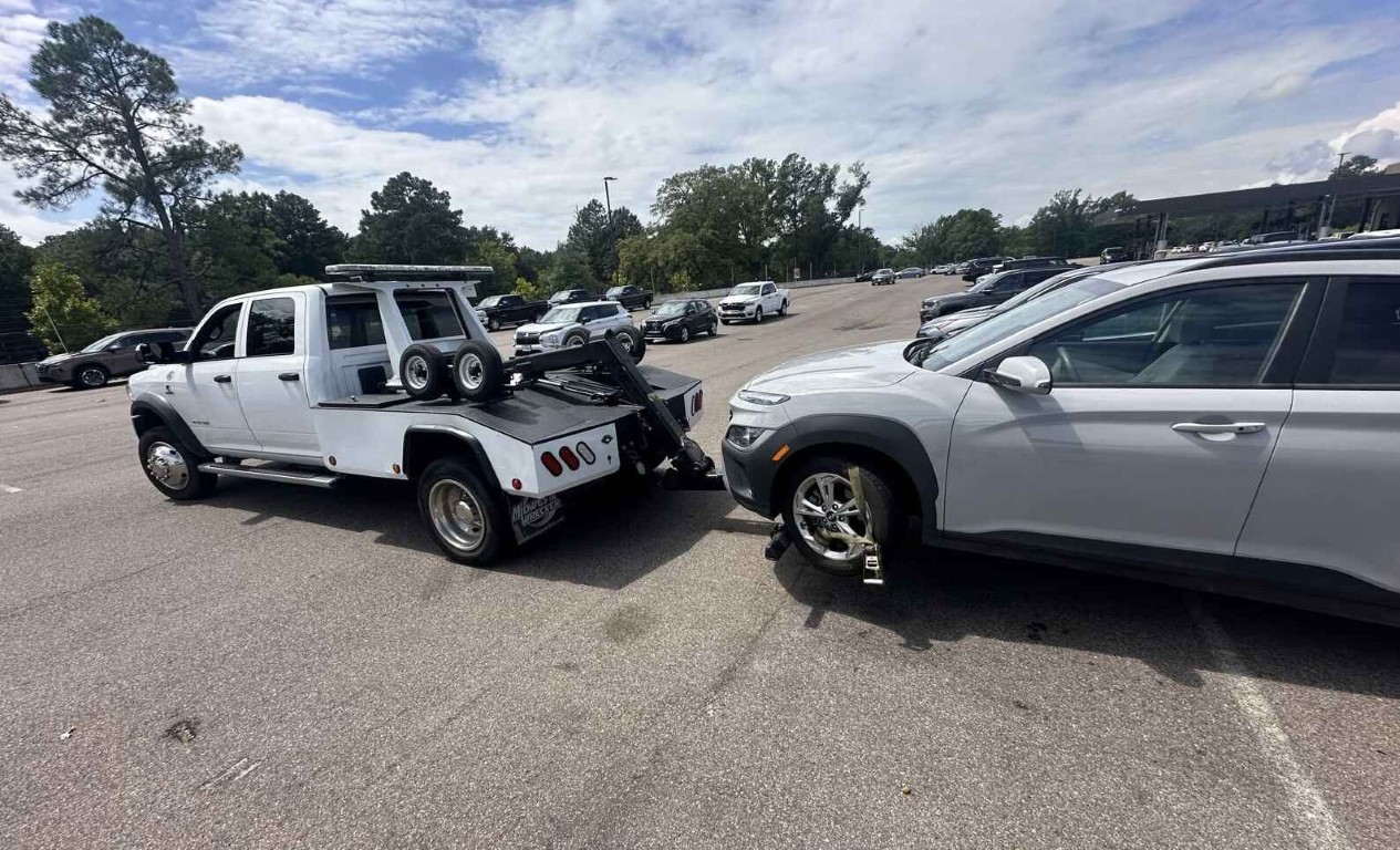 Accident recovery tow truck securing a damaged vehicle in North Babylon, NY